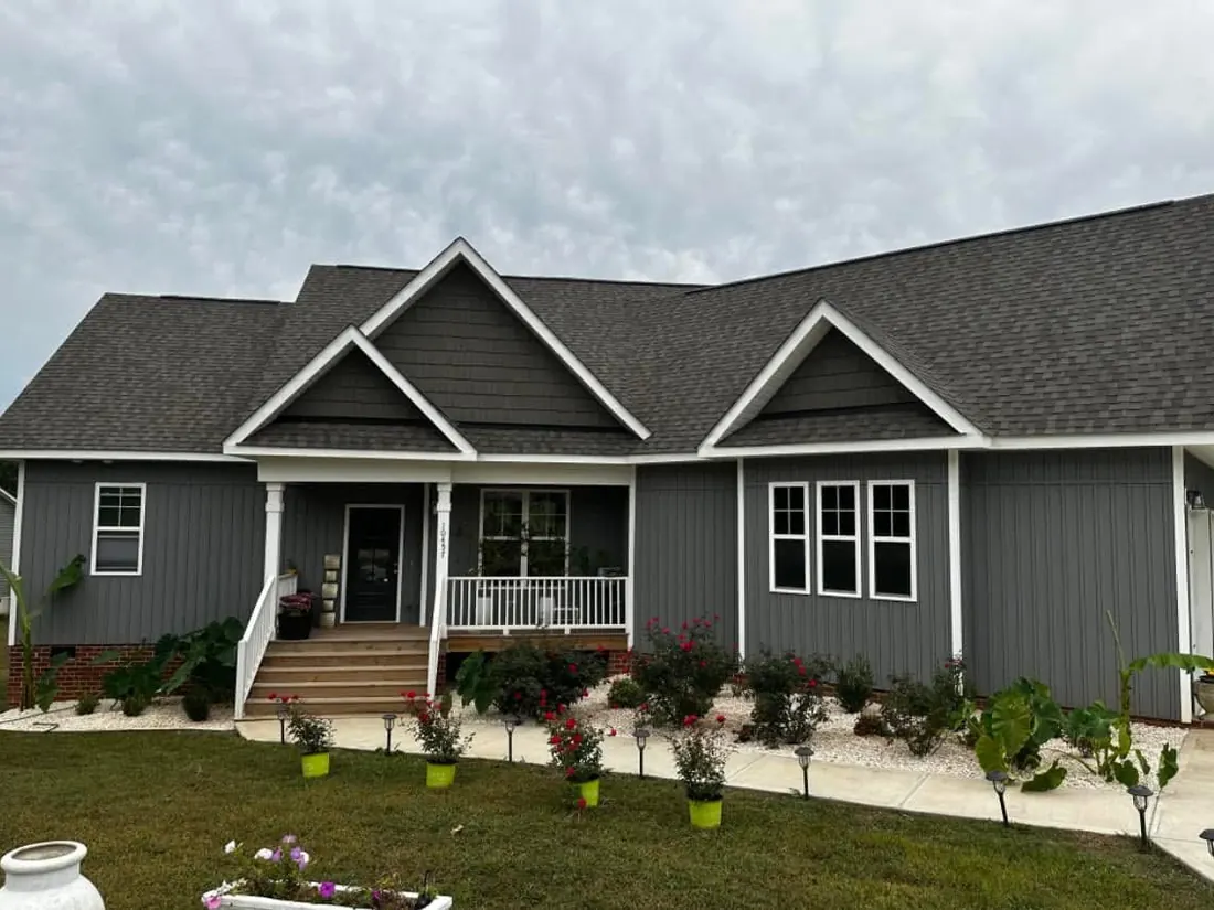 Flower beds and edging at a gray house